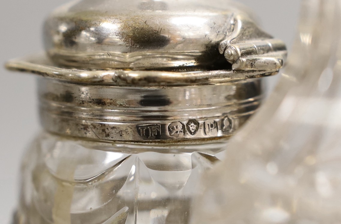 A graduated pair of William IV silver cruet stands, with ornate scroll handles, by John Fry II, London, 1830, both with four glass bottles, the largest with two silver mounted bottles, glass a.f., tallest 16cm, 34.3oz.